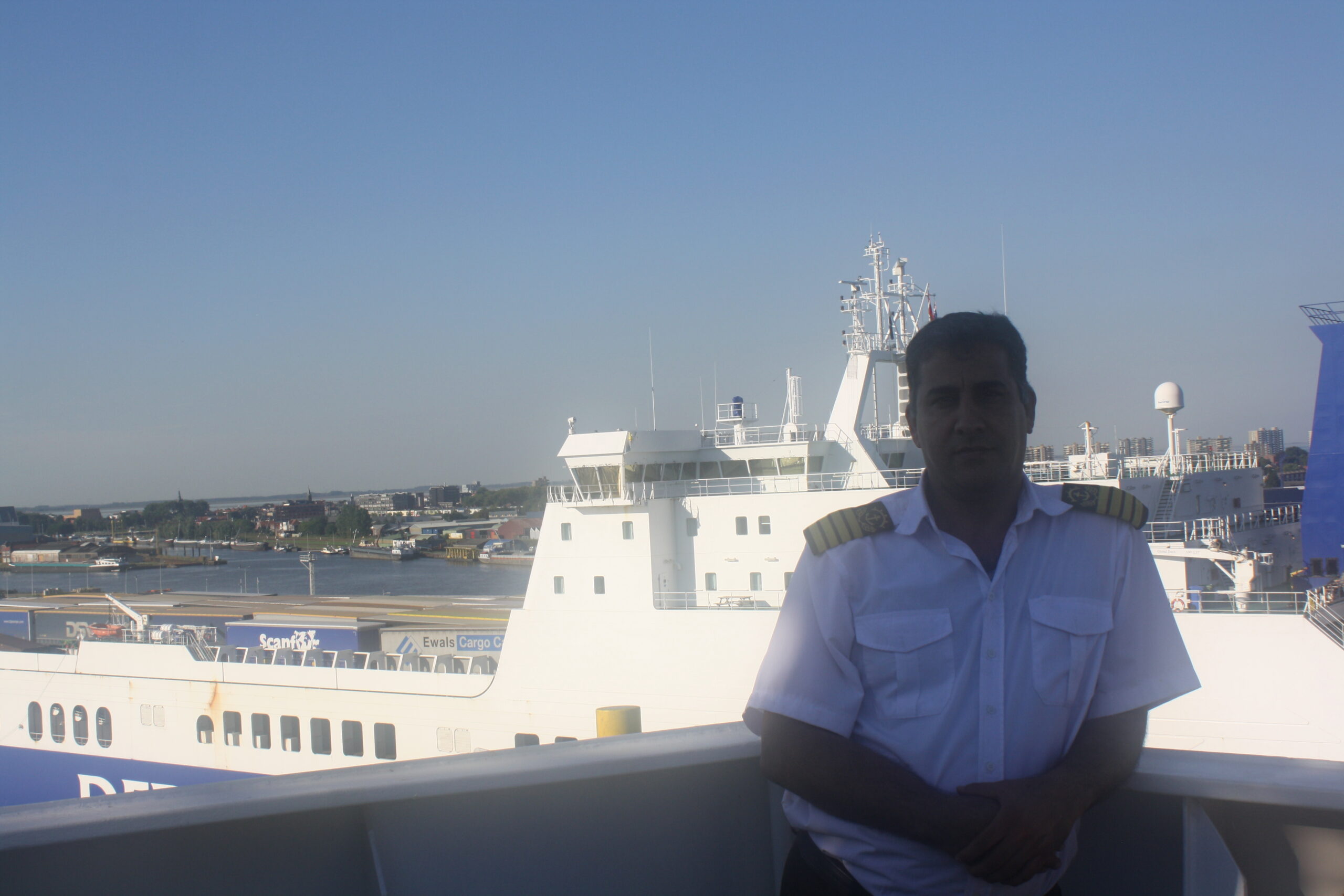 Surveyor in protective equipment attending a vessel at the terminal